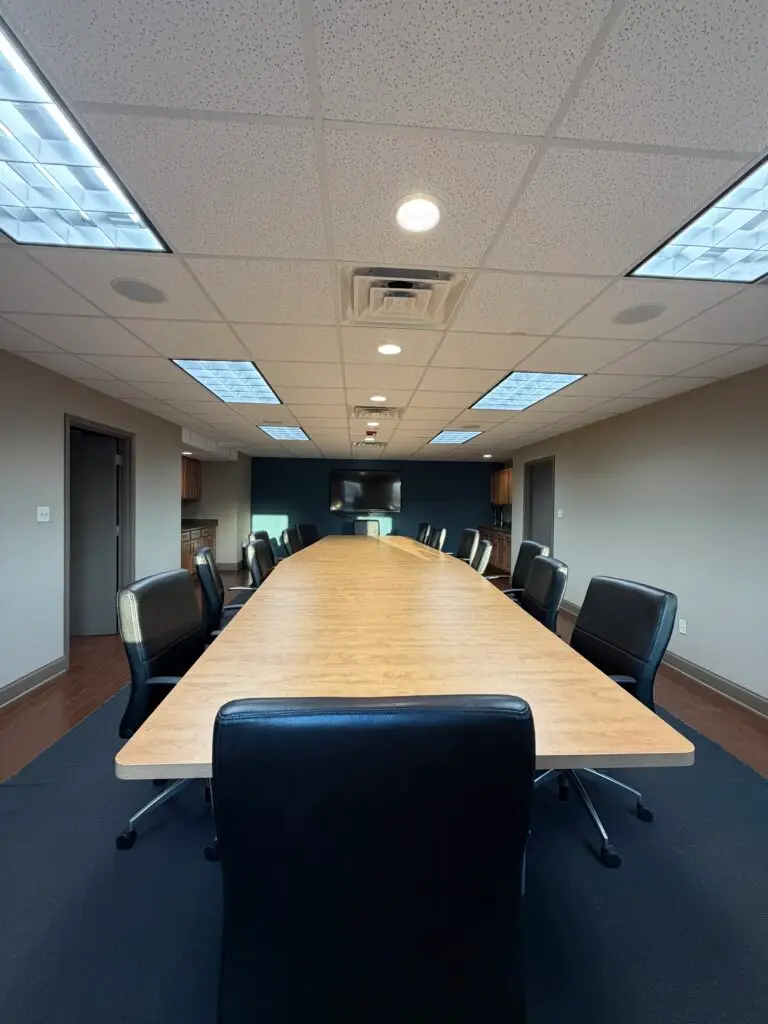 Boardroom Suites boardroom meeting space in Metairie with seating for 22 viewed from the table head staring at the TV