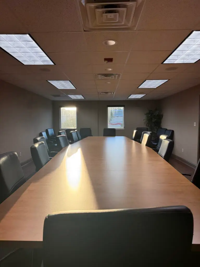 Boardroom Suites boardroom in Metairie viewed from the head of the 22-seat conference table staring that the windows
