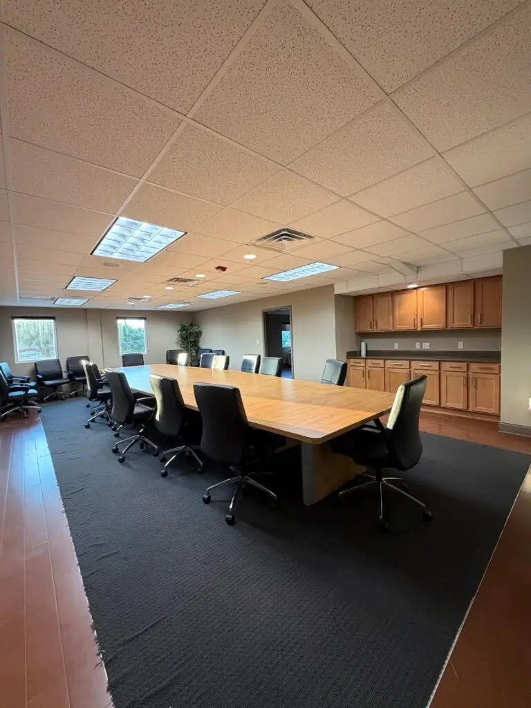 Boardroom Suites boardroom in Metairie showing 22-seat table and built-in cabinetry