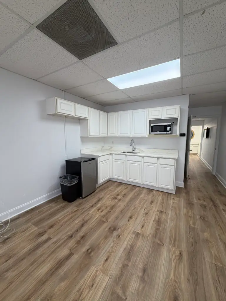 Suite 102 first-floor office in Metairie with private kitchenette, sink, microwave and refrigerator