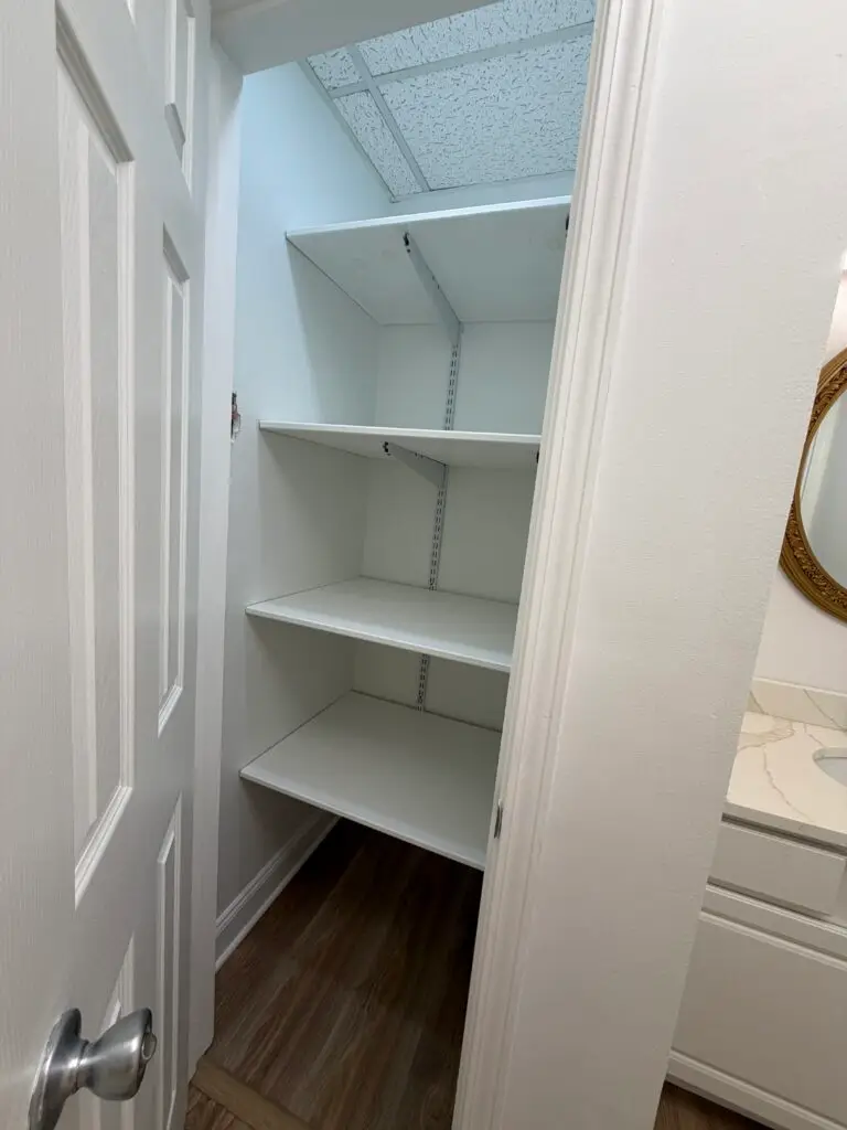 Suite 102 first-floor office in Metairie with built-in storage closet and shelving
