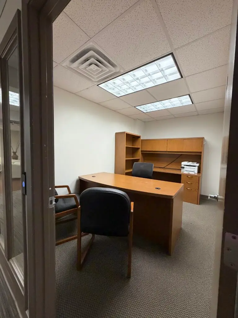 Boardroom Suites Suite 203 furnished private office in Metairie viewed from the hallway entrance