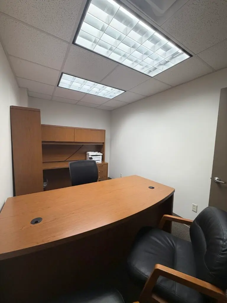 Boardroom Suites Suite 203 private office in Metairie with executive desk, guest seating and built-in storage