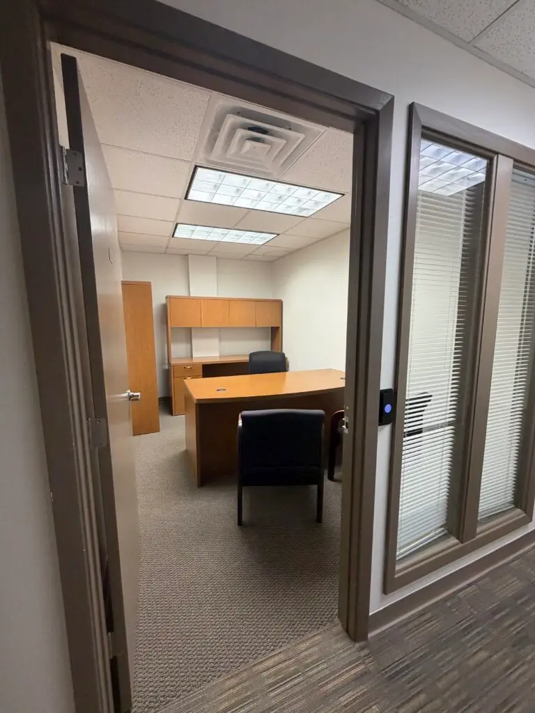 Boardroom Suites Suite 204 private office in Metairie viewed from the hallway entrance with desk and guest seating