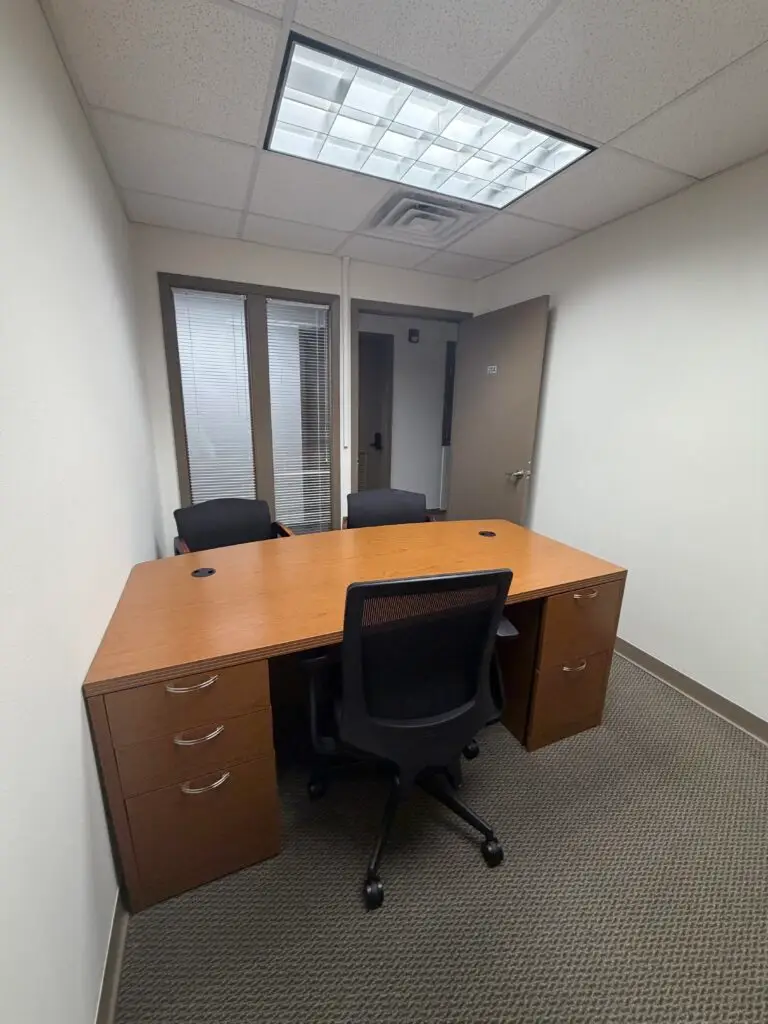 Boardroom Suites Suite 204 private office in Metairie showing desk, guest chairs and interior window