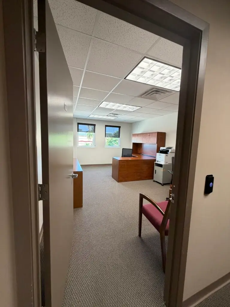 Boardroom Suites Suite 224 private office in Metairie viewed from the hallway entrance with two workstations and guest seating