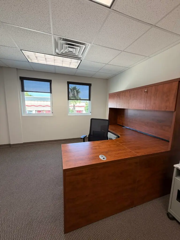 Boardroom Suites Suite 224 private office in Metairie with workstation, windows and built-in cabinetry