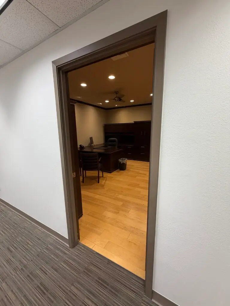 Boardroom Suites Suite 209 executive office in Metairie viewed from the hallway entrance with desk and built-in storage