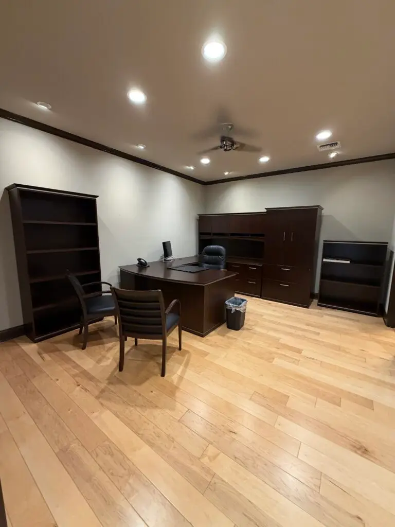 Boardroom Suites Suite 209 executive office in Metairie with desk, guest seating and hardwood floors