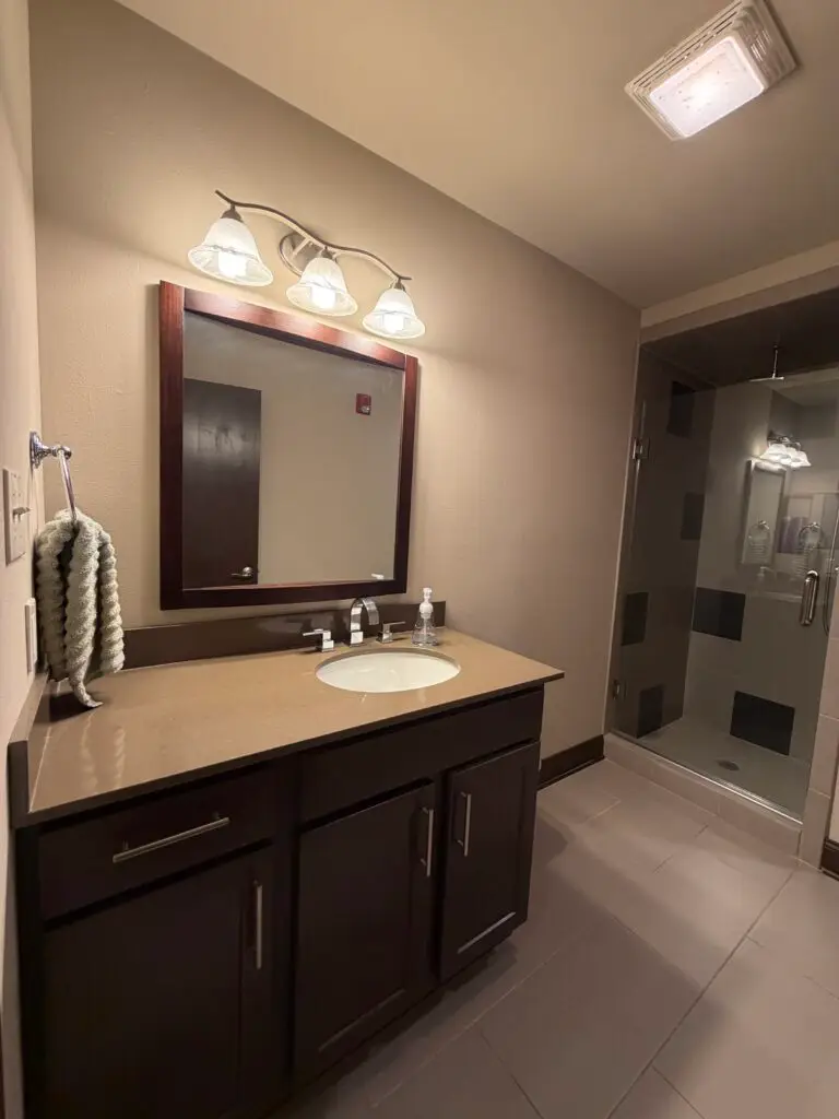 Boardroom Suites Suite 209 executive sitting area in Metairie with sofa, armchairs and hardwood floors