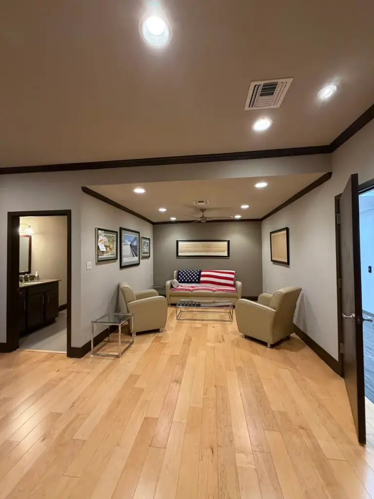Boardroom Suites Suite 209 private sitting area in Metairie with lounge seating and adjoining bathroom