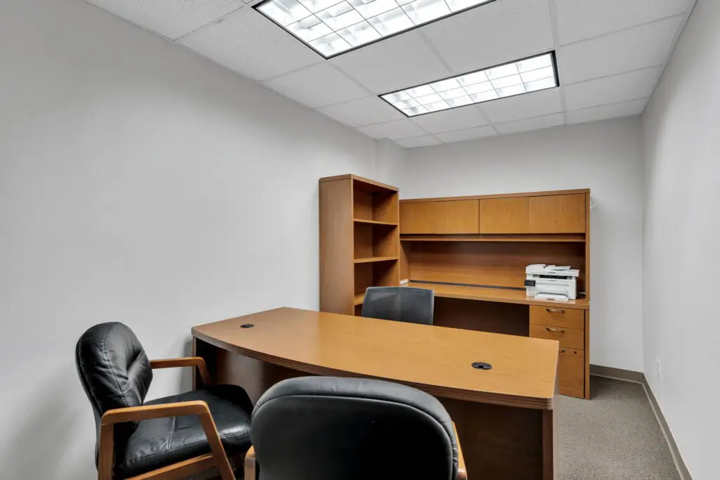 Boardroom Suites Suite 203 private office in Metairie with executive desk, guest seating and built-in storage